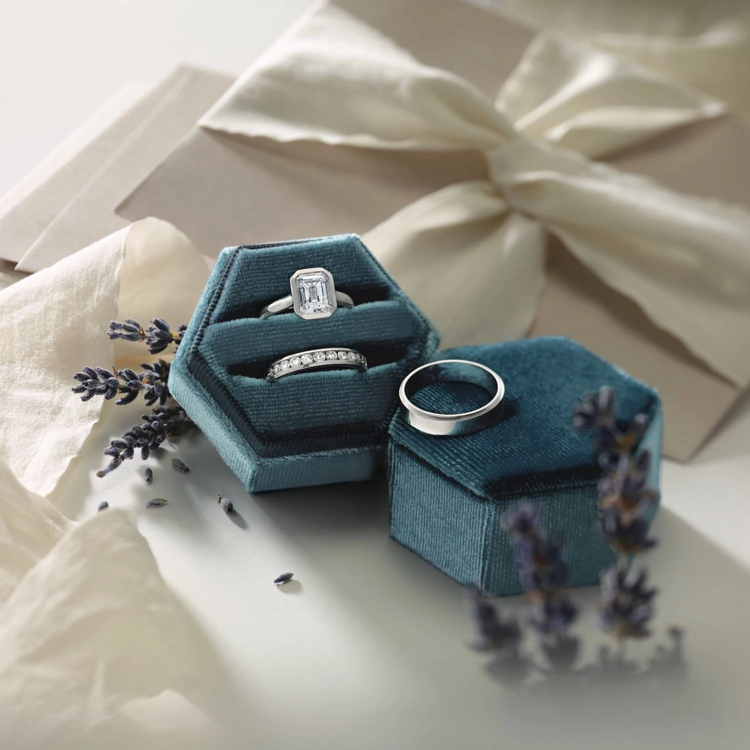 Emerald cut engagement ring and wedding band set in teal velvet box with lavender
