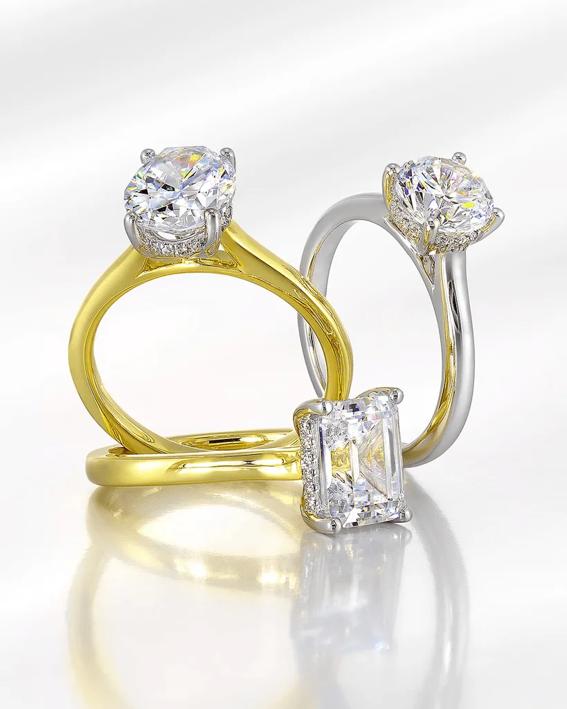 Gold and white gold solitaire engagement rings with round and emerald cut diamonds