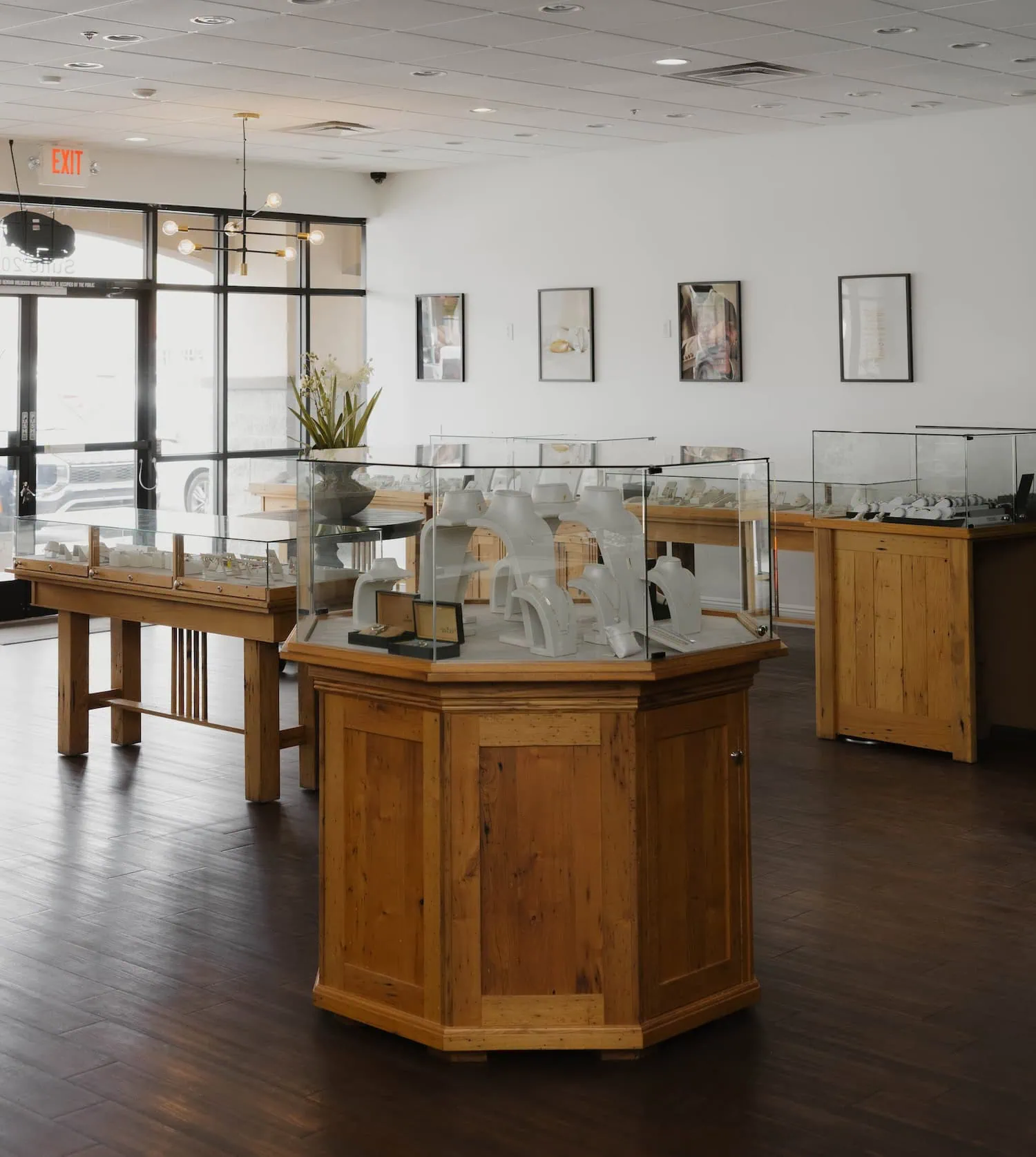 Inside V Jewelers showroom with glass display cases and natural wood furnishings in Surprise, AZ